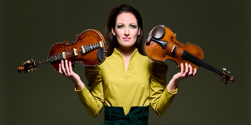 With the hardingfele in one hand and the violin in the other